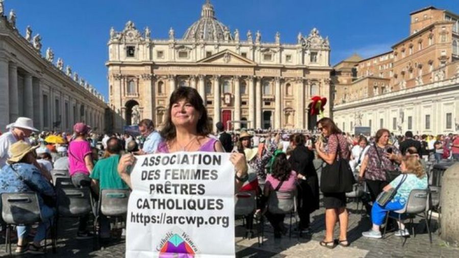 Christina Moreira with a protest sign in St. Peter's Square.