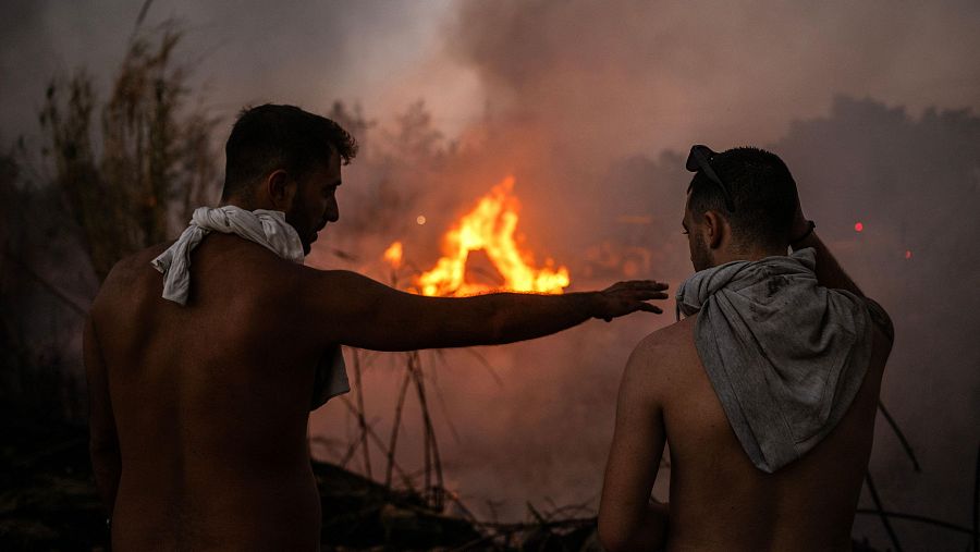 Voluntarios frente a un pequeño foco de fuego cerca de Penteli. Los incendios cerca de Atenas dejan una primera muerte.