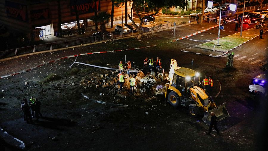 Miembros de las fuerzas de rescate israelíes inspeccionan los daños causados por un cohete en Haifa, norte de Israel