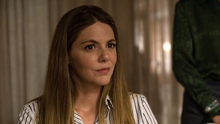 Michelle Jenner, con blusa de rayas, mira a alguien con expresión seria.