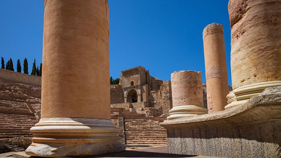 Columnas de mármol, algunas completas y otras fragmentadas, de las ruinas del teatro romano de Cartago Nova en Cartagena, España.  Restos arqueológicos visibles.