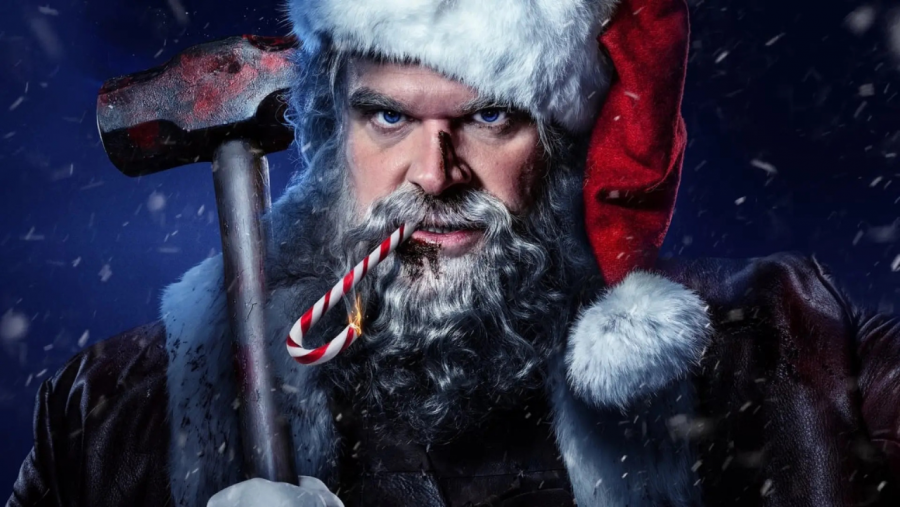 Santa Claus violento: David Harbour con traje oscuro, gorro de Papá Noel y martillo ensangrentado. Expresión amenazante.