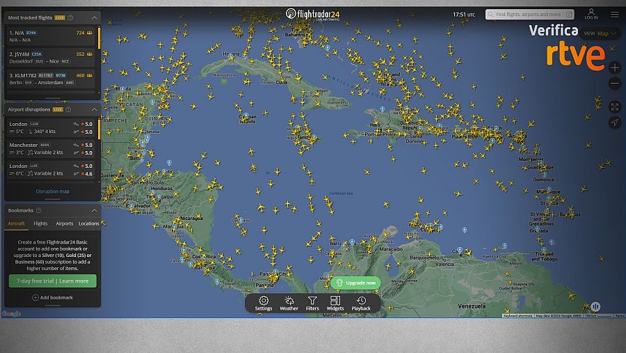 Vista de Flightradar24 con vuelos sobre el Caribe, datos de incidencias en aeropuertos (Londres y Manchester),  y opciones de ajustes, meteorología y filtros.  Incluye logo RTVE 'Verifica'.
