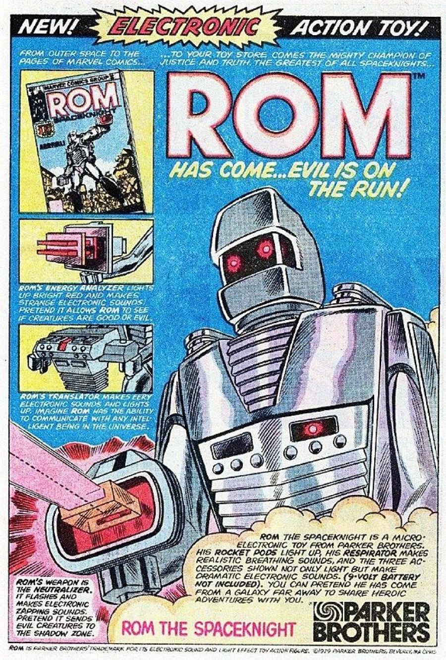 Anuncio de juguete electrónico de Rom: robot gris plateado con luces y sonidos, incluye Analizador de energía, Traductor y Neutralizador. ¡Batería no incluida!