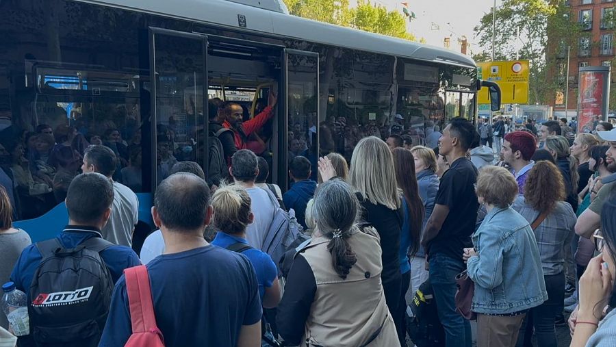 Varios pasajeros se amontonan para subir a un autobús en la Glorieta de Atocha