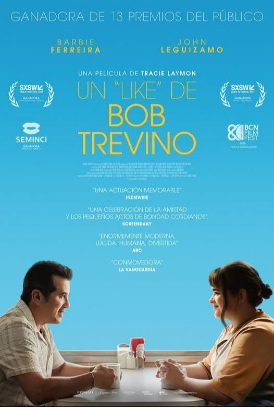 Barbie Ferreira y John Leguizamo en un cartel de película, sentados y sonrientes.  Premios del público en SXSW y SEMINCI.