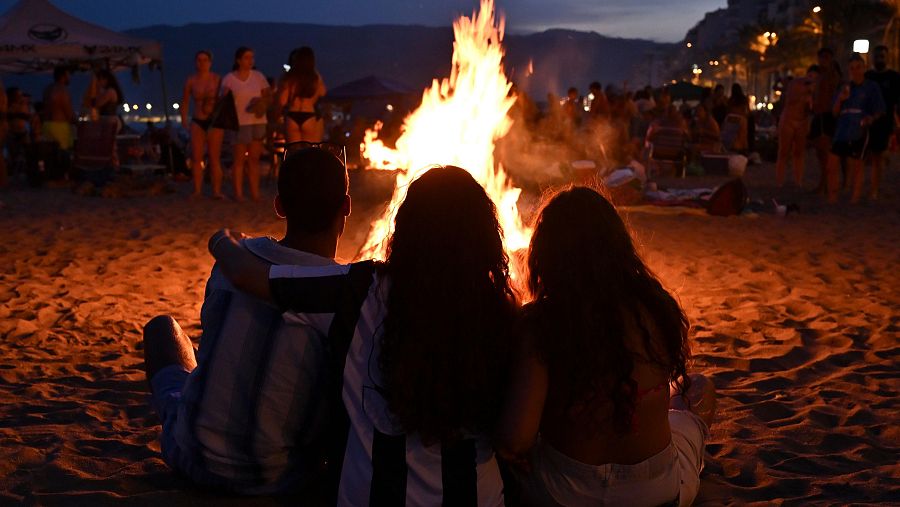 Varias personas disfrutan de la noche de San Juan que se celebra hoy lunes en la Playa de El Zapillo de Almería
