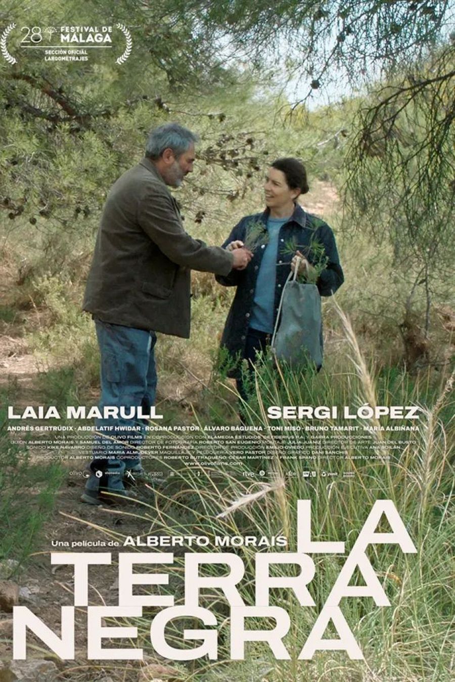 Cartel del Festival de Málaga: dos personas en un paisaje natural, uno ofreciendo algo a la otra. Título de la película: 