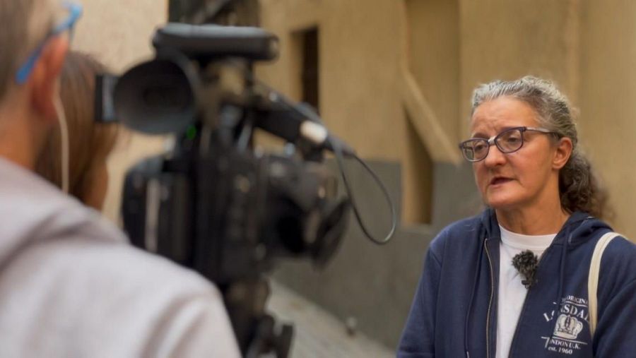 Pilar entrevistada por un medio de comunicación tras el coloquio de personas sin hogar.