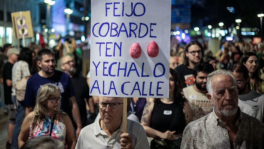 Un hombre sostiene una pancarta durante la marcha en Valencia
