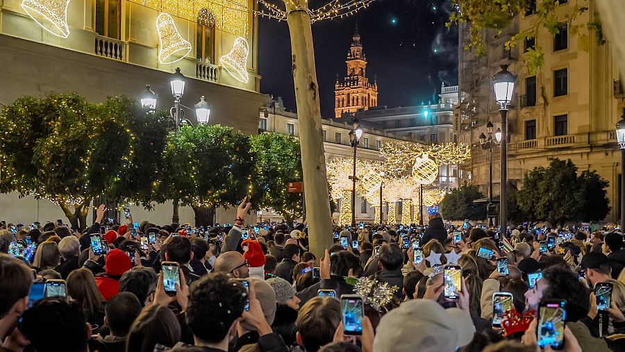 Miles de personas grabando con sus móviles la llegada del nuevo año en Sevilla.