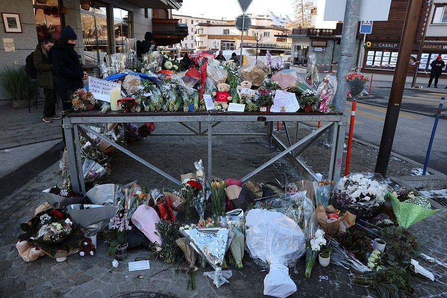 Ofrendas florales y ositos de peluche frente al bar Le Constellation