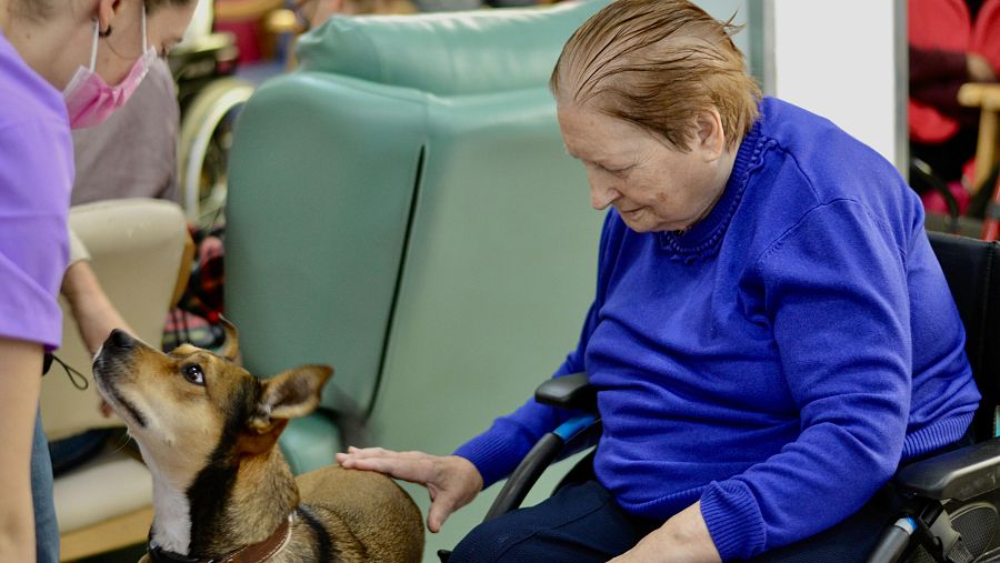 Paulina, residente de Aedes, acariciando a Frida