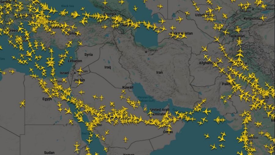 Un mapa de Oriente Medio muestra el espacio aéreo con iconos amarillos que representan aviones, indicando la densidad del tráfico aéreo en diferentes zonas. Se distinguen países y la ciudad de Teherán.