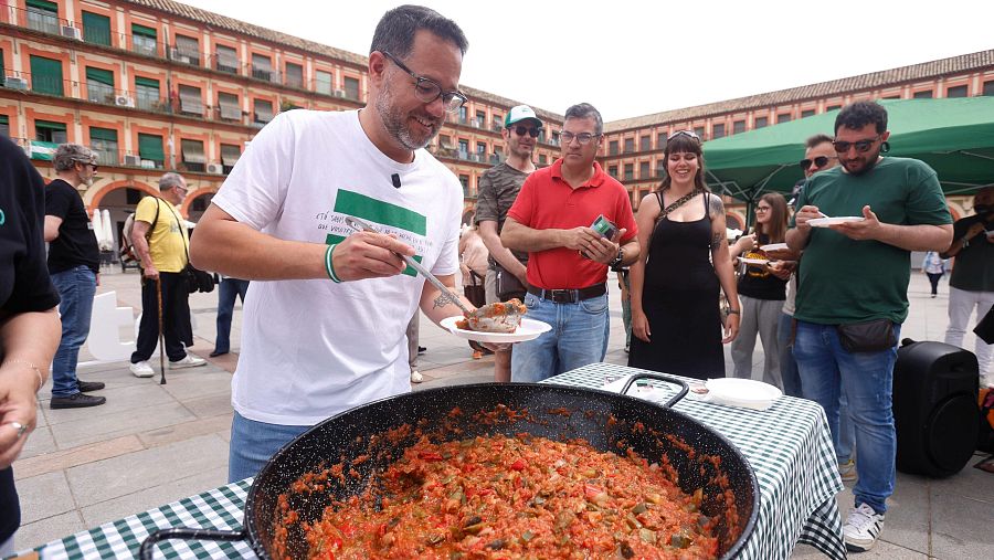 El candidato de Adelante Andalucía a la Presidencia de la Junta, José Ignacio García, sirve este sábado en Córdoba una comida con pisto y salmorejo.