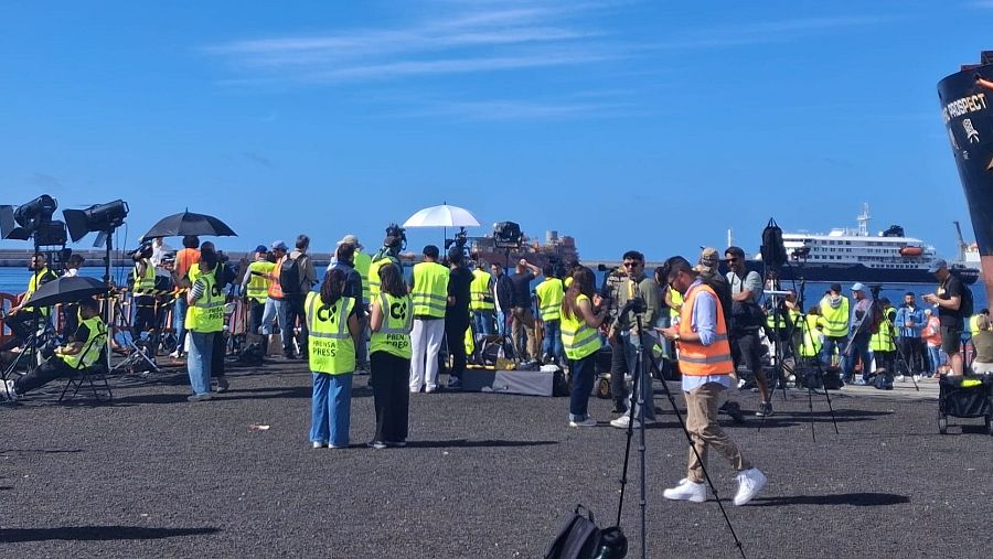 Periodistas ataviados con chalecos reflectantes durante el desembarco de los pasajeros del Hondius