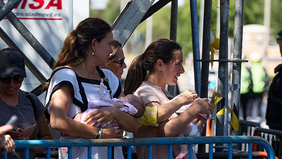 Varias personas con sus bebés esperan la salida del Papa León XIV de la Nunciatura Apostólica