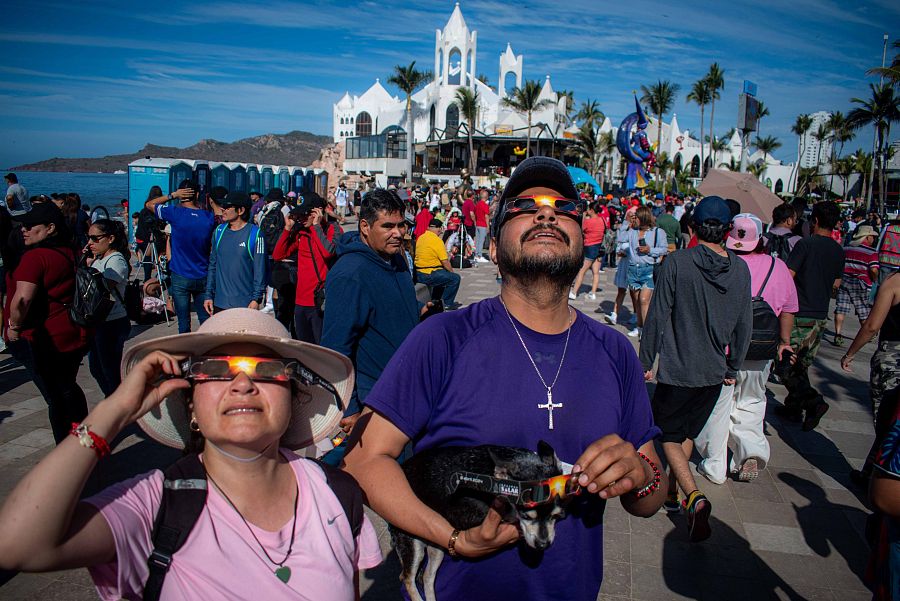 Varias personas disfrutan del eclipse solar total de 2024 en Mazatlán, México
