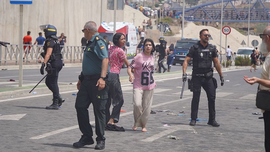 Dos mujeres, rodeadas de varios agentes de la Policía y Guardia Civil, tras llegar a Ceuta