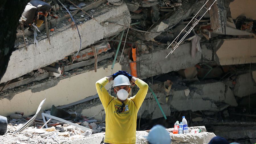 Un rescatista se lleva las manos a la cabeza mientras participa en una jornada de búsqueda entre los escombros de una edificación tras el terremoto