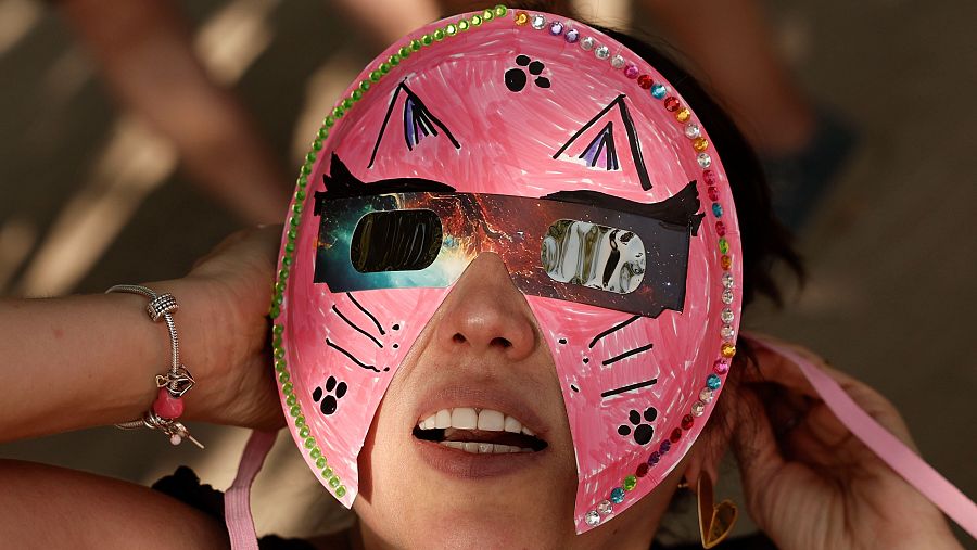 Una persona con máscara y gafas espera el eclipse de Sol en Madrid este miércoles