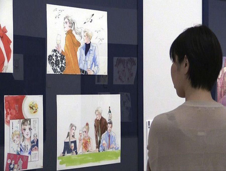 Una mujer observa ilustraciones de un cómic japonés en la exposición 