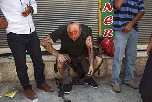Un hombre intenta reponerse tras resultar herido en la explosión de un artefacto en un centro cultural en Suruc, provincia de Sanliurfa (Turquía). EFE