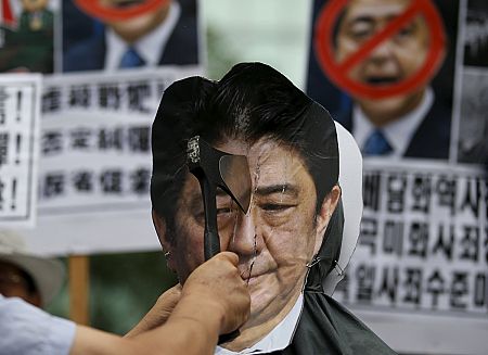 Manifestantes mostrando pancartas contra Shinzo Abe