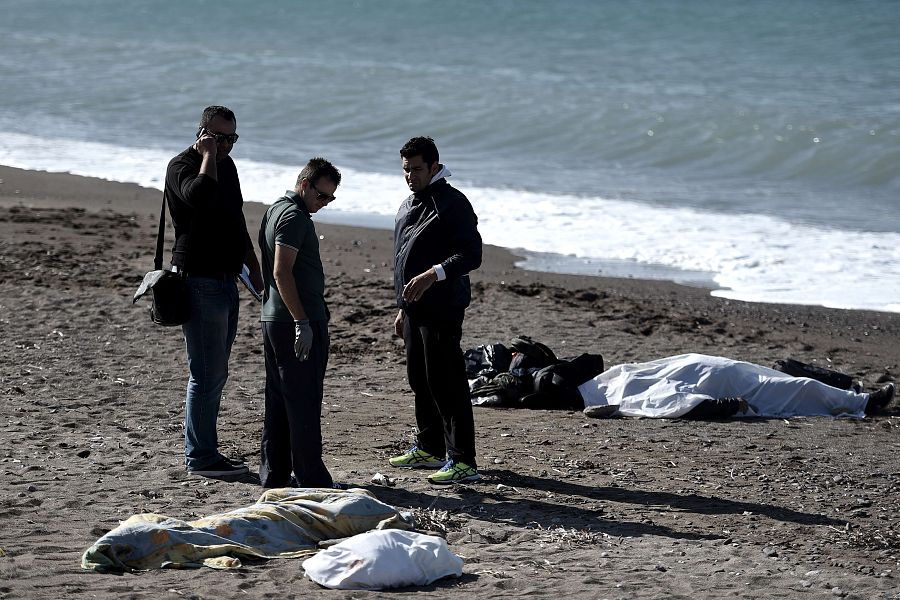 Los cadáveres de un hom,bre y un niño ahogados permanecen cubiertos en una playa de Lesbos