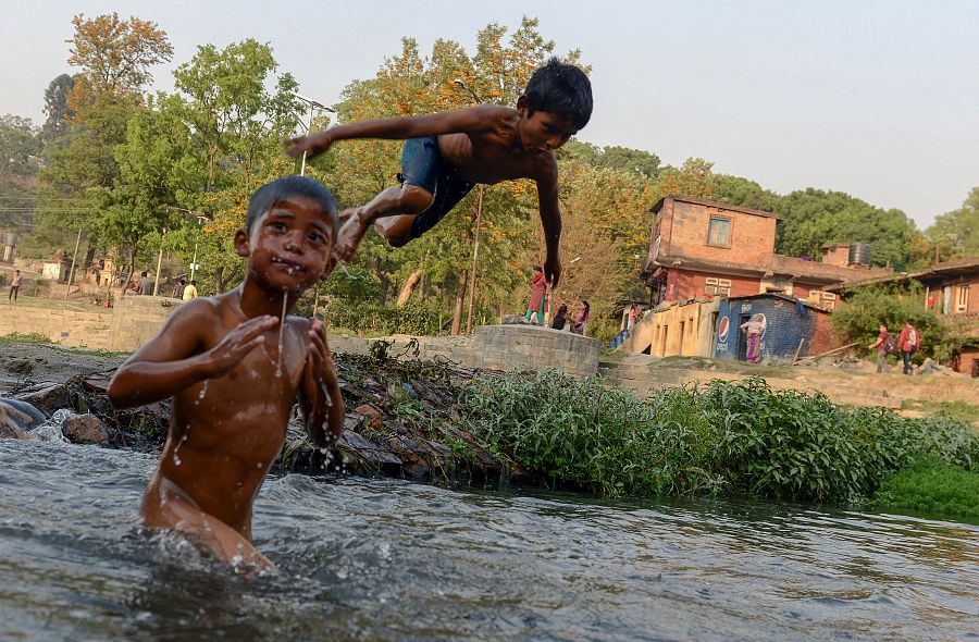 Unos niños juegan en un río en Katmandú