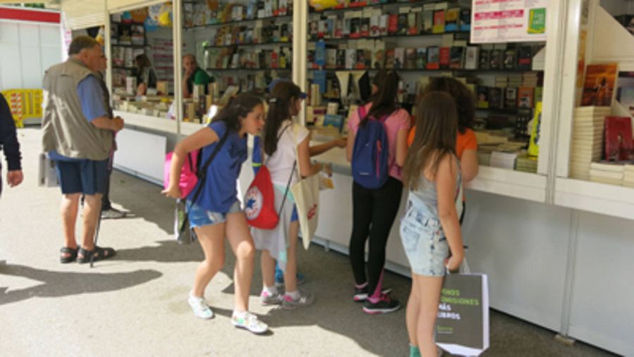 Unos niños curiosean delante de una caseta