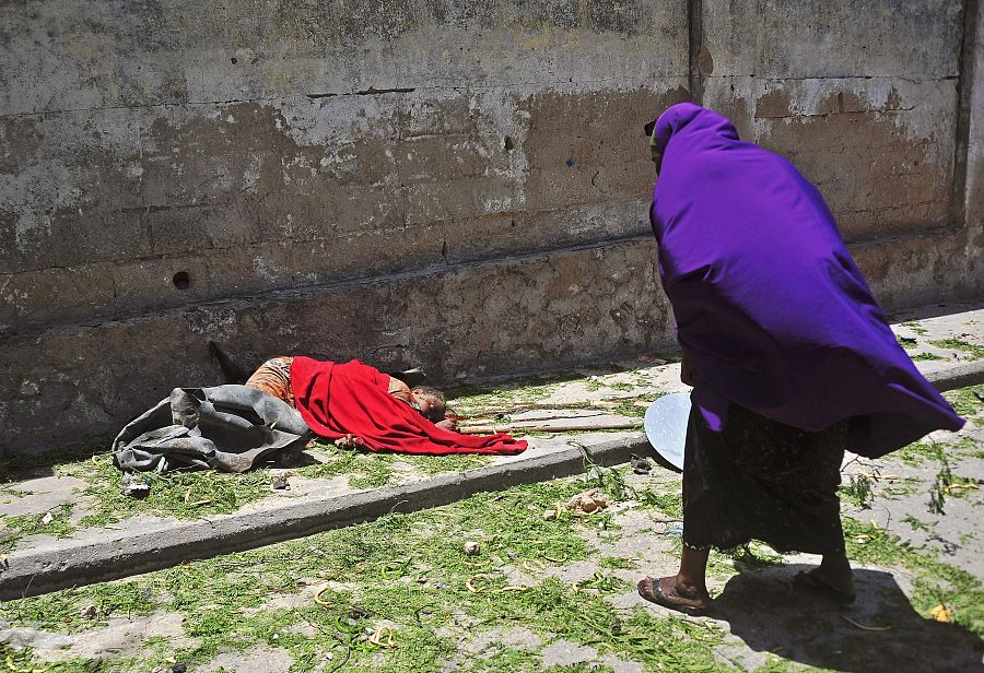 Una mujer inspecciona el cuerpo de una de las víctimas del atentado en Mogadiscio.