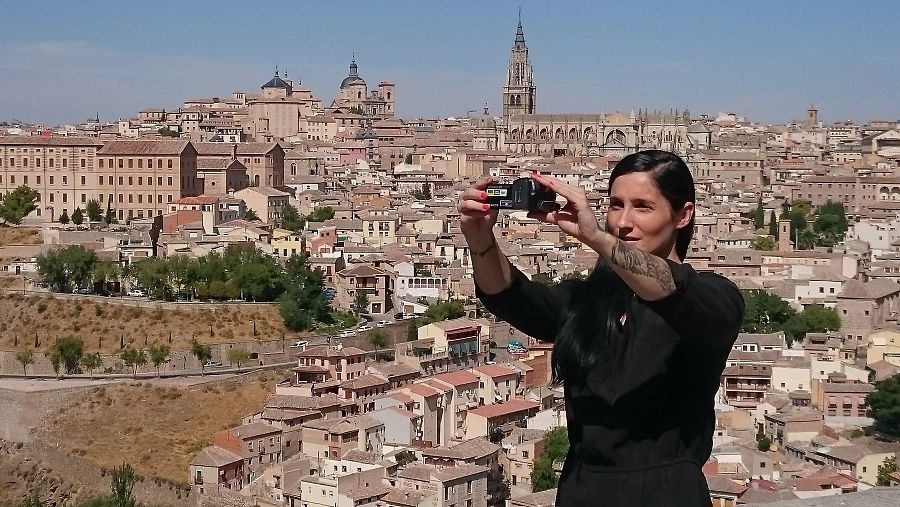 La presentadora de 'La mitad invisible' Clara Peñalver, se hace un 'selfie' ante la ciudad de Toledo