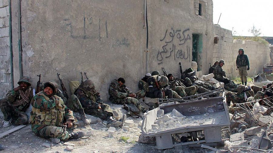 Soldados sirios descansan en una calle tras una batalla en el barrio Sheij Said de Alepo