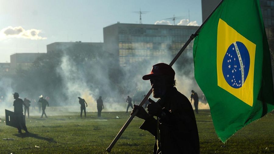 Un manifestante porta una bandera de Brasil durante la manifestación