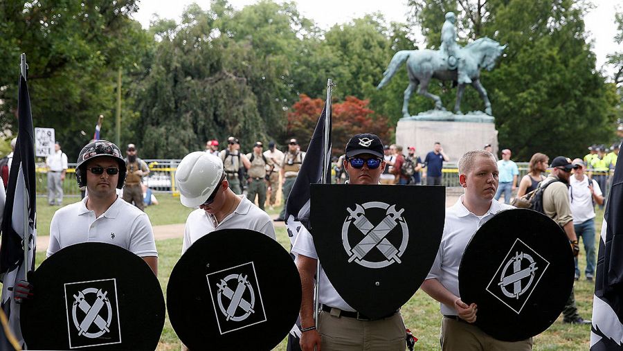 Varios jóvenes con los escudos y los símbolos del grupo neonazi Vanguard America en la concentración de Charlottesville