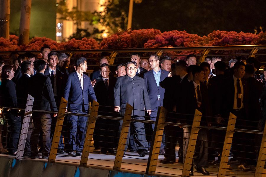 Kim Jong-un y su séquito cruzan a pie el puente Jubilee de Singapur, durnate su paseo nocturno