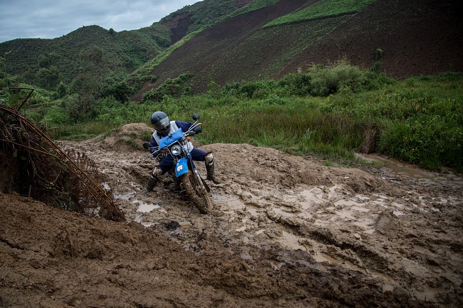 Un motorista se desplaza por un camino embarrado hacia Numbi (R.D. Congo)