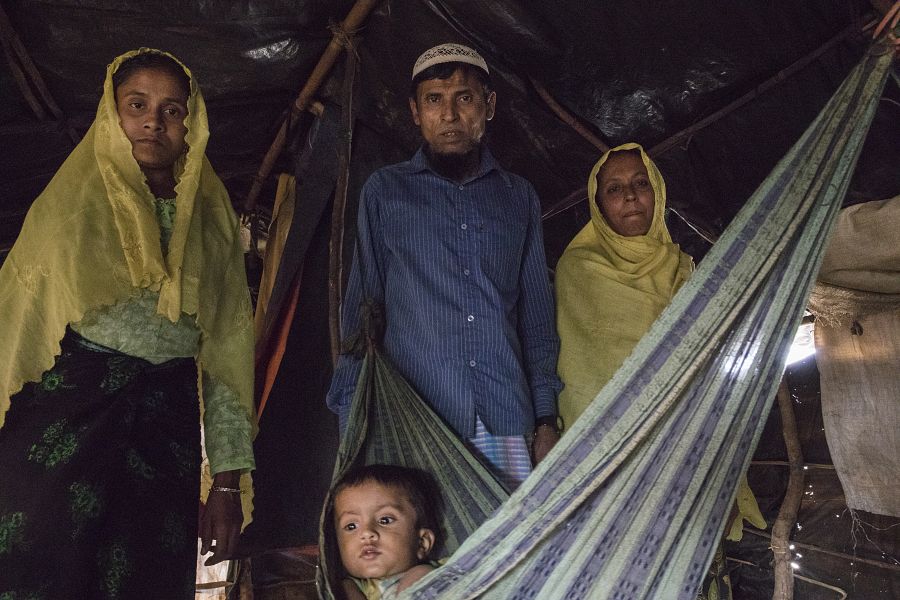 Hussein, con su familia, en el interior de la tienda en la que viven