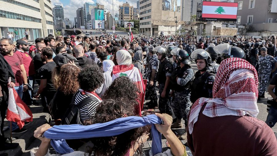 La policía libanesa separa a militantes de las organizaciones chiíes Hizbulá y Amal y a manifestantes contra el Gobierno en Beirut. EFE/EPA/NABIL MOUNZER