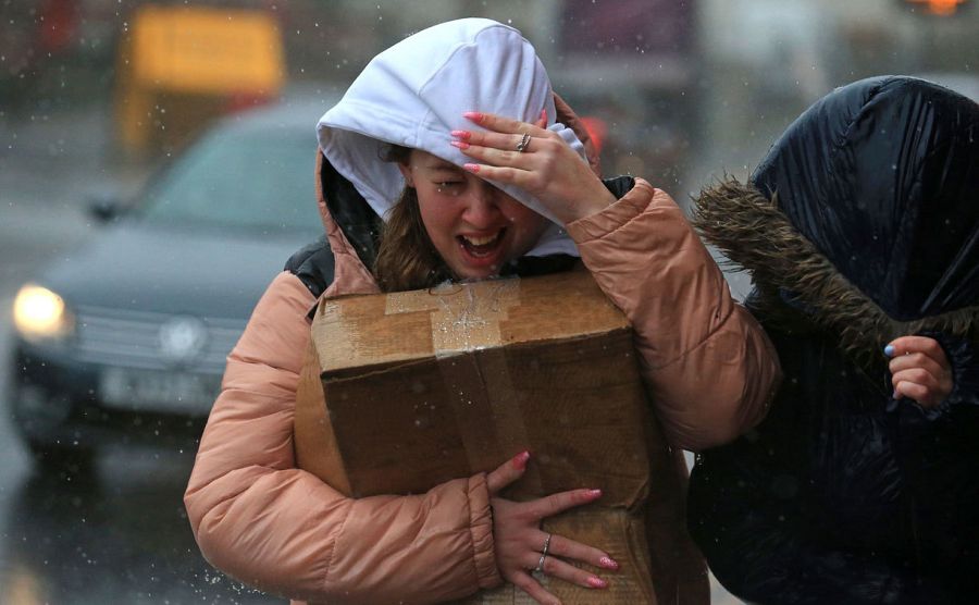 Una mujer intenta protegerse de los fuertes vientos y la lluvia en Sheffield, en el norte de Inglaterra, mientras la tormenta Ciara azota el país.
