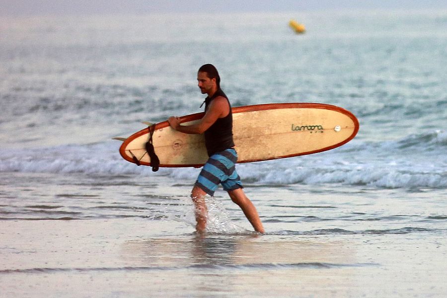 Hugo Silva hace surf en la playa
