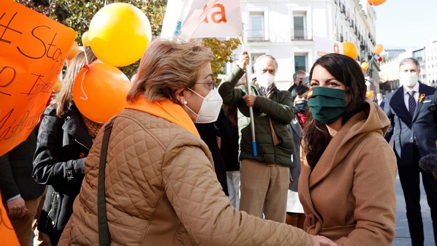 La diputada de Vox en el Congreso, Macarena Olona saluda a los integrantes de la Plataforma Más Plurales que se manifiesta en contra la ley Celaá, en frente del Congreso este viernes.