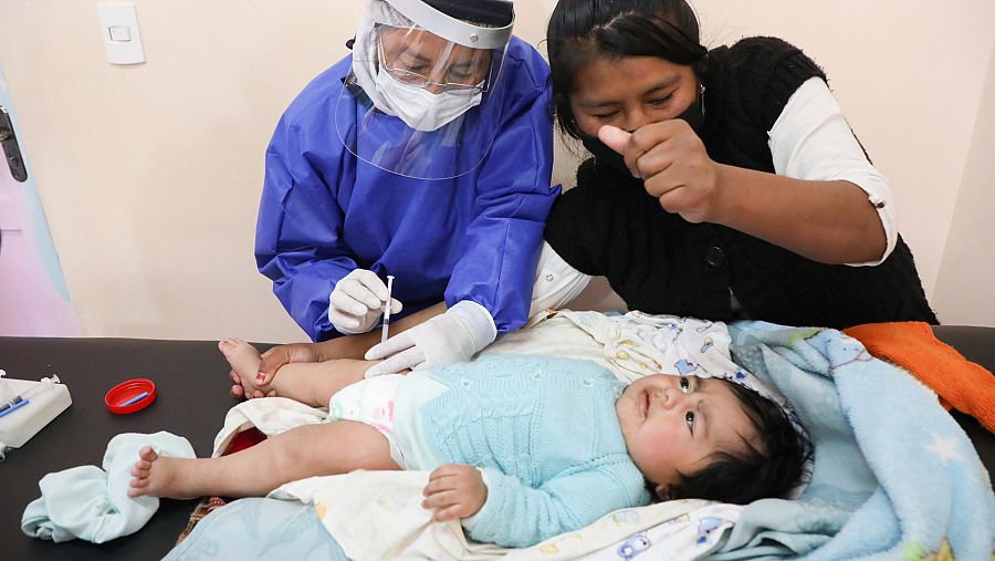 Zulema León distrae a su bebé en el momento de recibir la vacuna.