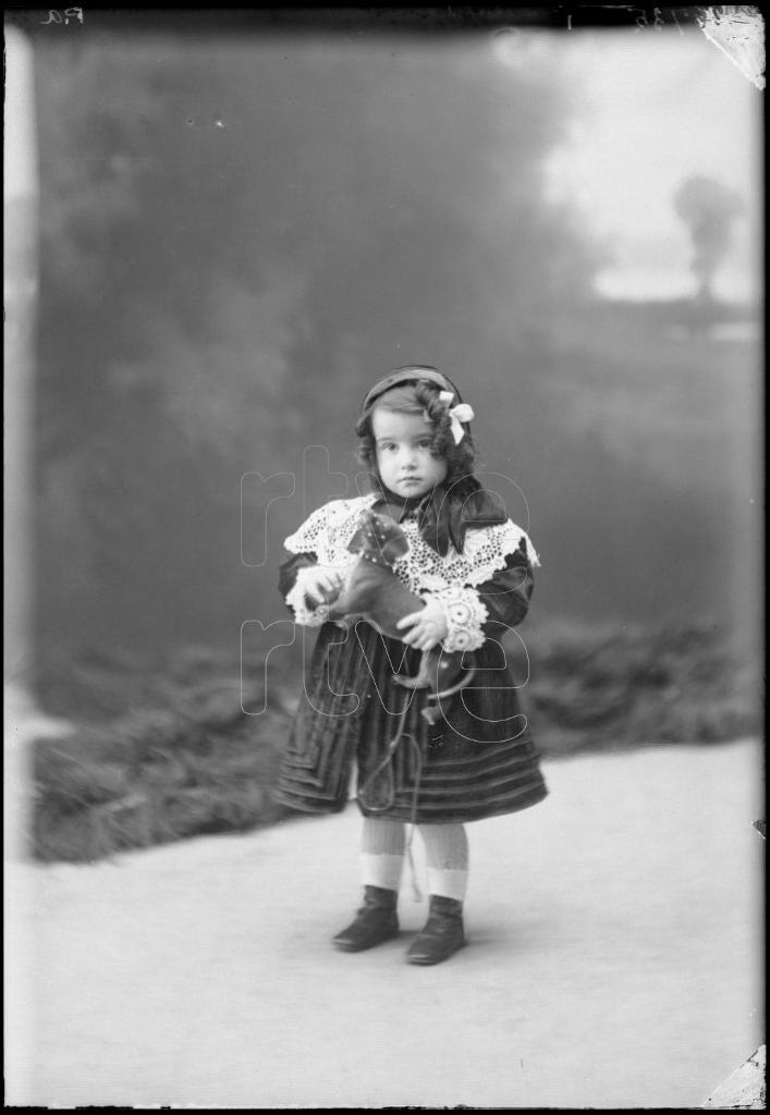 NIÑA DE CORTA EDAD CON UN PERRO DE JUGUETE