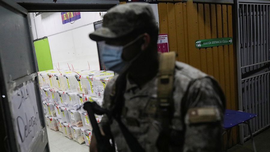 Un militar custodia las urnas con los votos en un centro electoral de Santiago de Chile