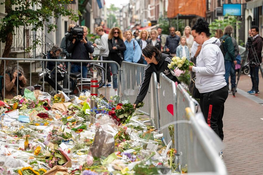La gente deposita flores por Peter R. de Vries en el centro de Amsterdam