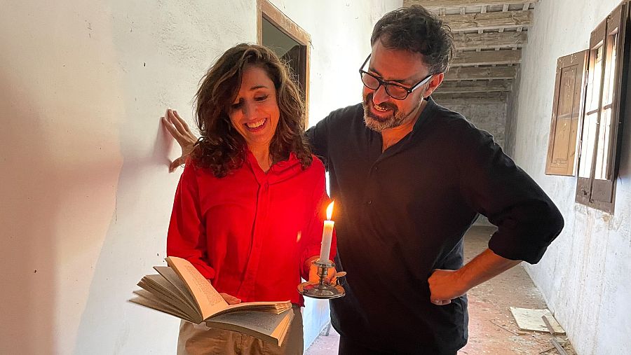 Anna Bertran amb Lluís Danés llegint un llibre amb una espelma