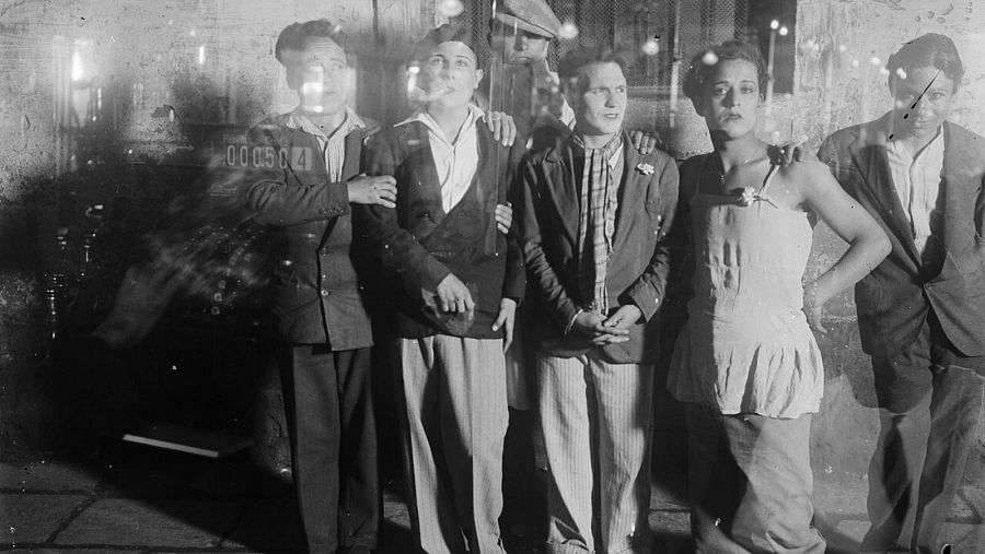 Grup de transvestits fotografiats des de l'interior de l'aparador de Cal Sacristà, al carrer Cid de Barcelona, 1925-1935