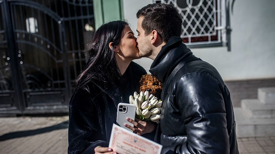 Una pareja de ucranianos se besa al salir del registro civil de Ivano Frankivsk tras casarse